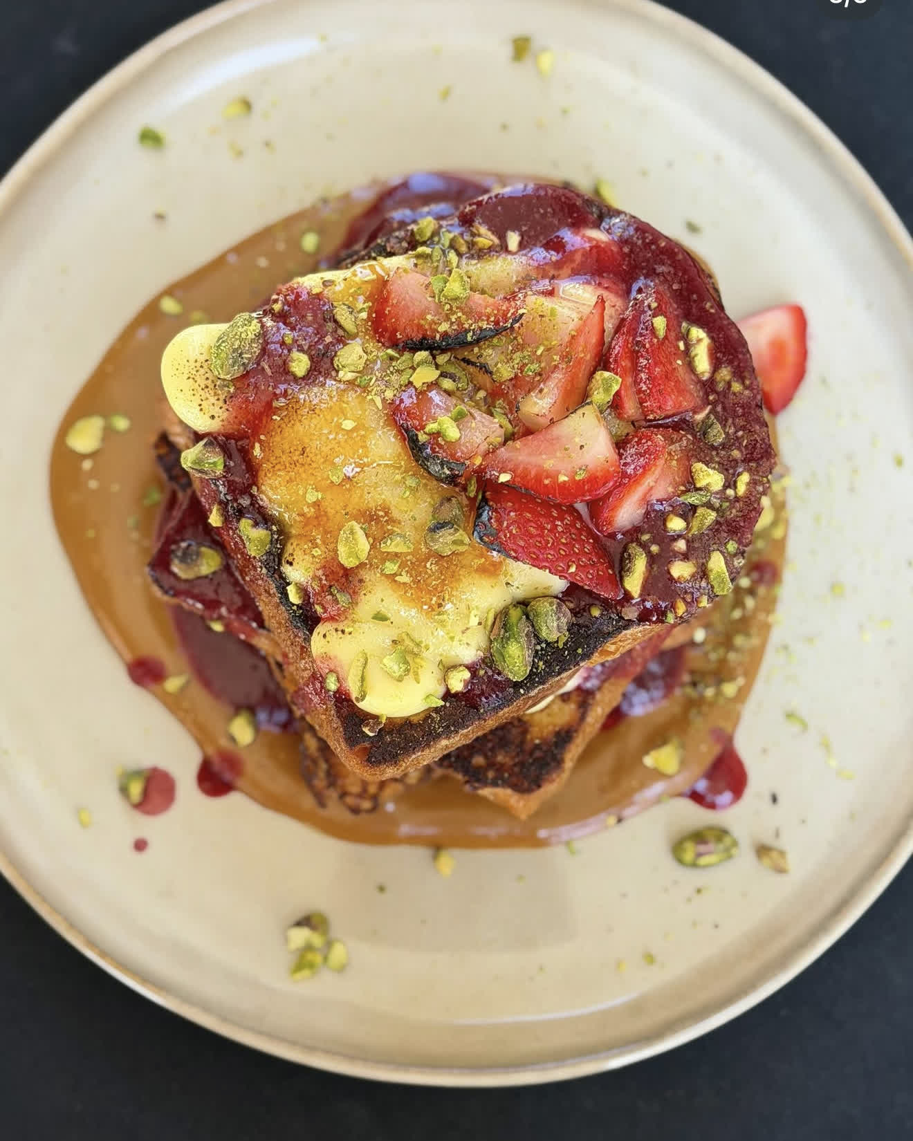 Brioche French toast with strawberries, pistachio and dulce de leche
