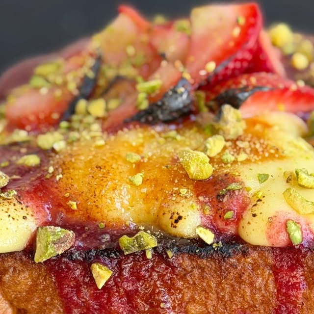 French toast close-up with custard and berries