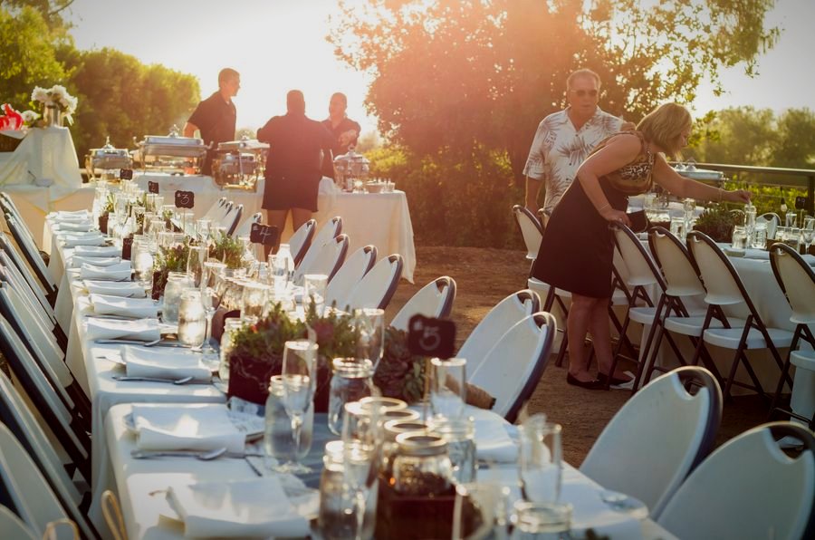 A long welcome-dinner table at golden hour