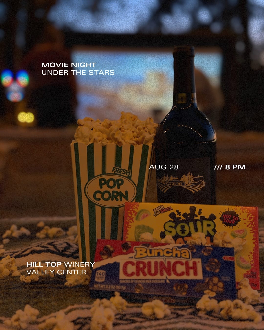 Popcorn, candy and a bottle of wine for movie night under the stars