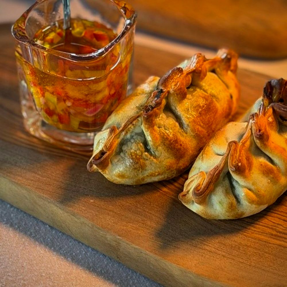 Handmade Argentine empanadas with salsa criolla