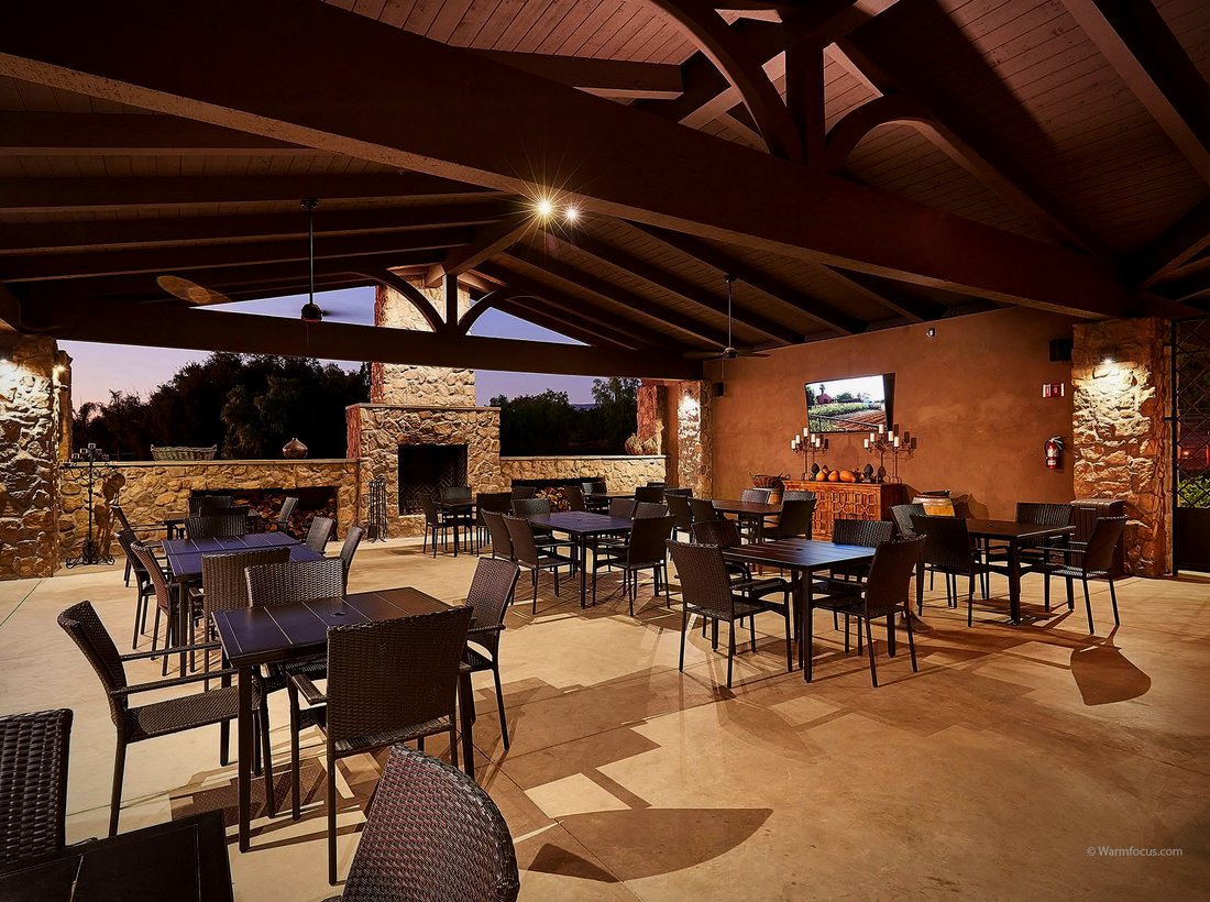 The covered Hill Top patio with fireplace and wood beams