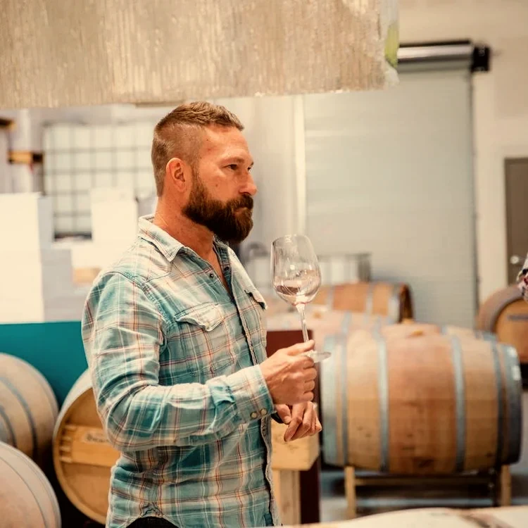 Steve Michaliszyn, winemaker at Hill Top Winery, tasting a glass in the cellar